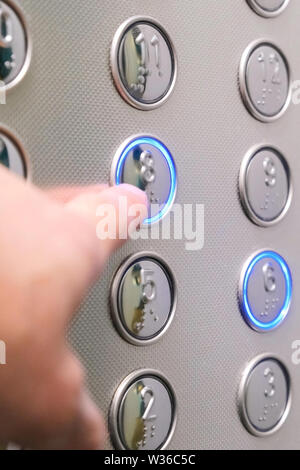 Tactile digit icons for the visually impaired. Elevator buttons. Selective focus close-up Stock Photo