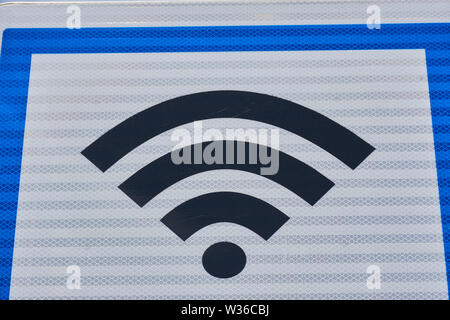 signboard with free wifi symbol on white background in blue frame Stock Photo
