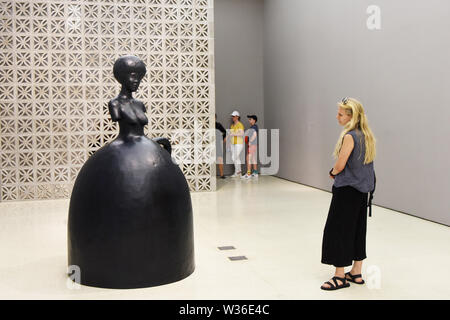 New York, USA. 12th July, 2019. A visitor views a statue at the exhibition 'the Hugo Boss Prize 2018: Simone Leigh, Loophole of Retreat' at the Guggenheim Museum in New York, the United States, July 12, 2019. The Solomon R. Guggenheim Museum in New York City, often referred to as The Guggenheim, has been added to UNESCO's World Heritage List.    The museum is among eight buildings in the United States that were inscribed on the list under the title of The 20th-Century Architecture of Frank Lloyd Wright. Credit: Xinhua/Alamy Live News Stock Photo