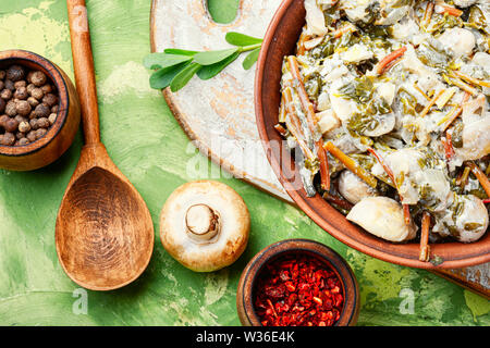 Stewed mushrooms in sour cream with portulak.Russian cuisine Stock Photo