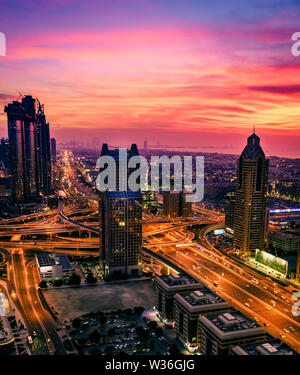 Bird's eye view of Dubai downtown buildings and Sheikh Zayed Road after sunset Stock Photo