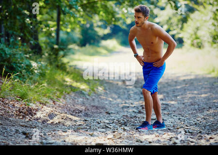 Young man resting during trial running Stock Photo