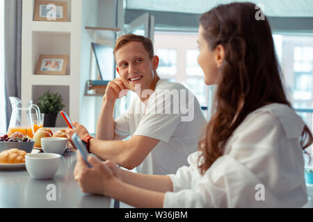 Couple of freelancers using smartphones during breakfast Stock Photo