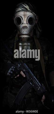 Soldier in a gas mask with a automatic rifle Stock Photo