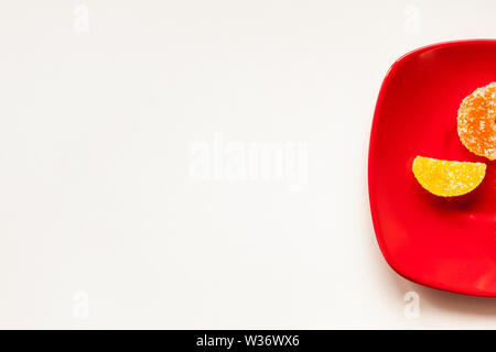 Two Sugar candies on a red plate Stock Photo