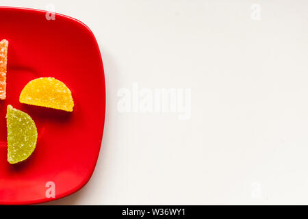Two Sugar candies on a red plate Stock Photo