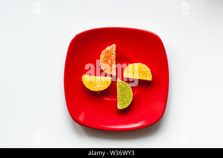 Four Sugar candies on a red plate Stock Photo