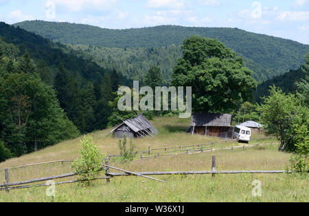 View of the apiary farm in the Carpathians. Sheds, car parked. July 18, 2018. Lugi village, Ukraine Stock Photo