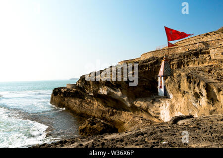 Panning shot from a hindu temple nestled in a cliff overlooking the arabian sea in Diu Gujarat india Stock Photo