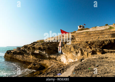 Panning shot from a hindu temple nestled in a cliff overlooking the arabian sea in Diu Gujarat india Stock Photo