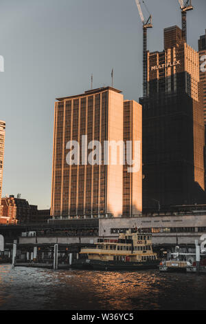 Sydney, New South Wales, Australia - JUNE 30th, 2018: A ferry leaves Circular Quay in the late afternoon light on a Sunday. Stock Photo