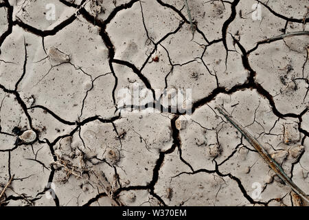 An Abstract background Texture Of Dry Cracked Earth In A Drought Stock Photo