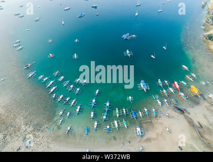 Aerial drone view of boats anchored in the bay with clear and turquoise water. Boats and yachts in the tropical lagoon. Tropical landscape. Stock Photo