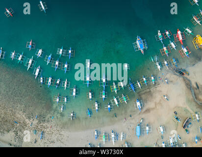 Aerial drone view of boats anchored in the bay with clear and turquoise water. Boats and yachts in the tropical lagoon. Tropical landscape.