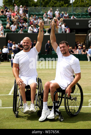 Joachim Gerard and Stefan Olsson following their victory in the men's wheelchair doubles final on day twelve of the Wimbledon Championships at the All England Lawn Tennis and Croquet Club, Wimbledon. Stock Photo