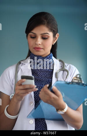 Female doctor text messaging Stock Photo