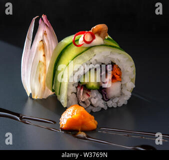 Sushi and Sashimi maki rolls nigiri and inside out maki rolls artistically arranged with regional ingredients Stock Photo