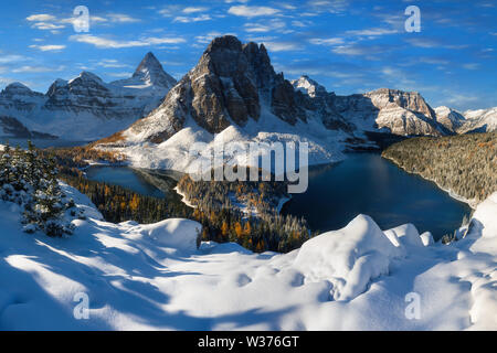 Winter sunset. Mount Assiniboine, also known as Assiniboine Mountain, is a pyramidal peak mountain located on the Great Divide on the British Columbia Stock Photo