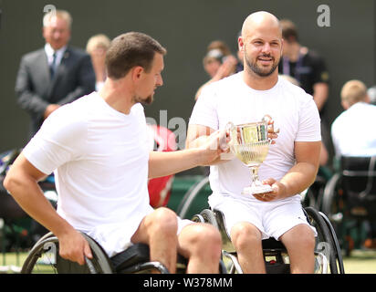 Joachim Gerard (left) and Stefan Olsson following their victory in the men's wheelchair doubles final on day twelve of the Wimbledon Championships at the All England Lawn tennis and Croquet Club, Wimbledon. Stock Photo