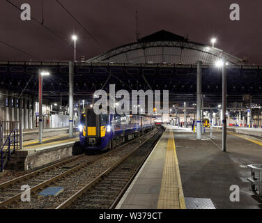 Scotrail class 385 electric train 385104 at Glasgow Queen street waiting to depart with a train to Alloa at night Stock Photo