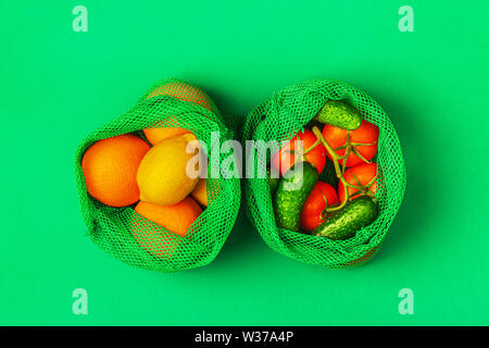 Fresh fruits and vegetables in reusable textile mesh bags, eco friendly shopping, zero waste concept. Stock Photo