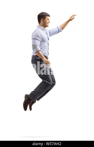 Full length profile shot of a professional young man jumping and gesturing with hand isolated on white background Stock Photo