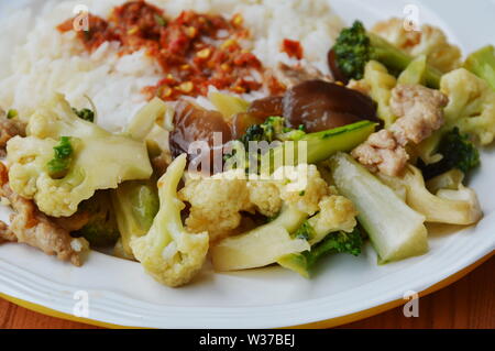 stir fried mixed vegetable with pork and spicy shrimp paste on rice Stock Photo