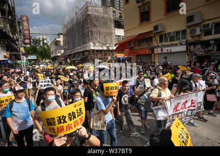 Protesters marching with placards during the demonstration.Thousands of protesters took to the street of the Sheung Shui district  in northern Hong Kong in an anti parallel trading march. Some protesters clashed with the police after the march. Numbers of protesters are reported to be injured. Stock Photo