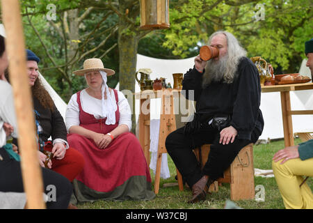 Medieval re-renactors attend the Tewkesbury Medieval Festival at Tewkesbury Battlefield in Gloucestershire. Stock Photo