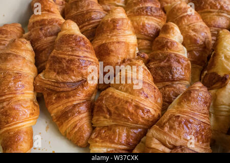 Freshly baked croissants closeup. Low depth of field bakery background Stock Photo