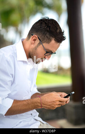 Young man using smart phone, businessmen on vacation Stock Photo