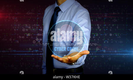 Man with skull symbol hologram on hand. Businessman showing futuristic concept of cyber attack, online crime, pirate, theft and fraud in cyberspace wi Stock Photo