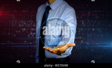 Man with dynamic cyber security with shield symbol hologram on hand. Businessman showing futuristic concept of digital protection, firewall and comput Stock Photo