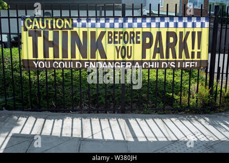 think before you park, sign aimed at drivers outside a school in twickenham, middlesex, england Stock Photo