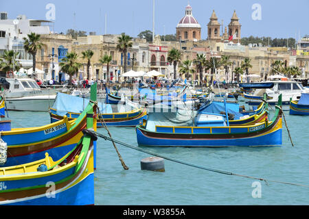 Traditional Maltese wooden fishing boat in harbor, Marsaxlokk, Malta, Europe Stock Photo