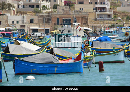 Traditional Maltese wooden fishing boat in harbor, Marsaxlokk, Malta, Europe Stock Photo