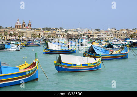 Traditional Maltese wooden fishing boat in harbor, Marsaxlokk, Malta, Europe Stock Photo