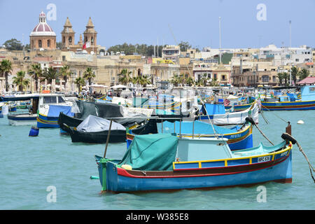 Traditional Maltese wooden fishing boat in harbor, Marsaxlokk, Malta, Europe Stock Photo