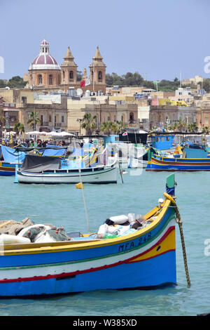 Traditional Maltese wooden fishing boat in harbor, Marsaxlokk, Malta, Europe Stock Photo