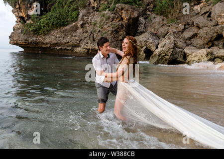 Newlyweds having fun at wedding day on tropical beach. Wedding couple. Stock Photo