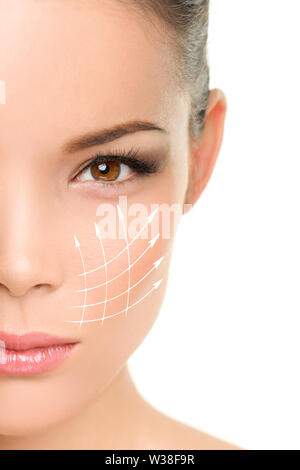 Face lift anti-aging treatment - Asian woman portrait with graphic lines showing facial lifting effect on skin. Stock Photo