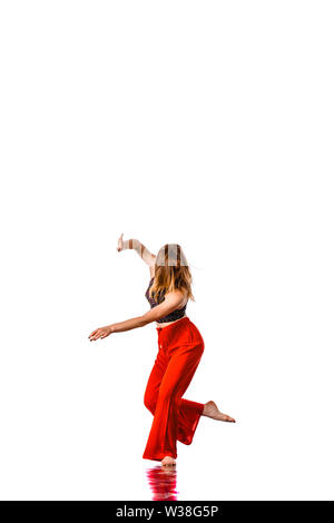 Happy girl working out dance standing with hands up. Dynamic woman fitness trainer dancing for fun Stock Photo