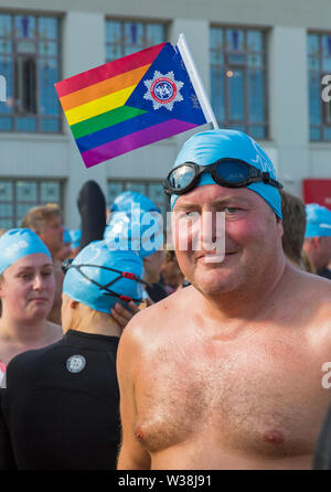 Bournemouth, Dorset, UK. 13th July, 2019. Pier to Pier sunset swim where swimmers brave the English Channel swimming from Bournemouth to Boscombe piers in 1.4 mile open water challenge, raising funds for BHF, British Heart Foundation. The inaugural sunset swim at Bournemouth where swimmers have 2 hours to complete the swim then relax on the beach to enjoy the sunset, ahead of two more Pier to Pier swims taking place tomorrow during the day - thousands take part in the three swims. A lovely warm sunny evening for the swim. Credit: Carolyn Jenkins/Alamy Live News Stock Photo