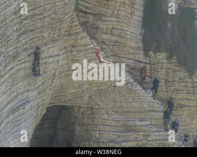 A diving contestant somersaults backwards while jumping from the height of the Pigeon Rocks during the Red Bull World Cliff Diving Championships which is held for over two days. Stock Photo