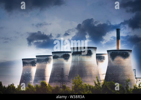 Energy Power Plant chimneys and cooling towers with dramatic sky. Polluting clean air showing climate change concepts...global warming Stock Photo