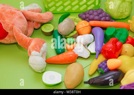 Toy fruits and grasszs . Fake fruits and vegetables .Plastic childrens toys in the form of fruit and vegetables Stock Photo