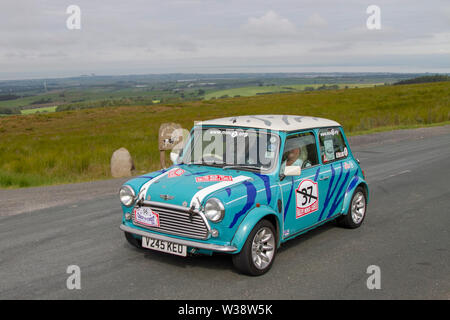 1999 blue Old type BMC British Leyland Rover Mini Cooper Sport at Scorton, Lancashire. UK Weather 13th July, 2019. Sunny conditions as the Lancashire Car Club Rally Coast to Coast crosses the Trough of Bowland. 90s vintage, classic, collectible, heritage, historics vehicles left Morecambe heading for a cross county journey over the Lancashire landscape to Whitby. A 170 mile trek over undulating landscape as part of the classics on tour car club annual event. Stock Photo