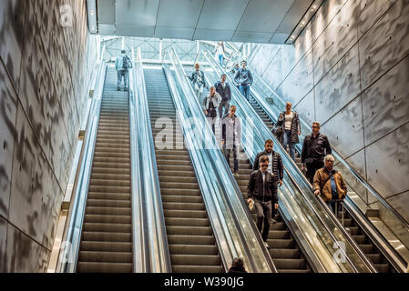 People going down the escalator at the railway station Triangeln in Malmoe, Sweden, May 21, 2019 Stock Photo