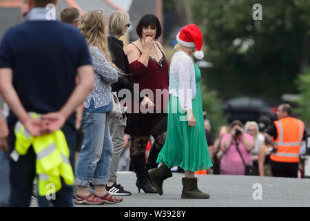 Barry, UK. 13th July, 2019. Co-writer Ruth Jones who plays 'Nesa' and Joanna Page who plays 'Stacey' rehearse a scene  whilst filming the BBC comedy Gavin & Stacey Christmas special in Trinity Street, Barry, South Wales. Credit: Mark Lewis/Alamy Live News Stock Photo