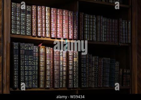 Old vintage books on shelf in library Stock Photo